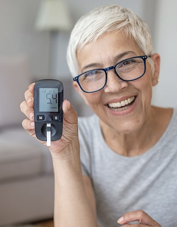 old lady smiling with a device